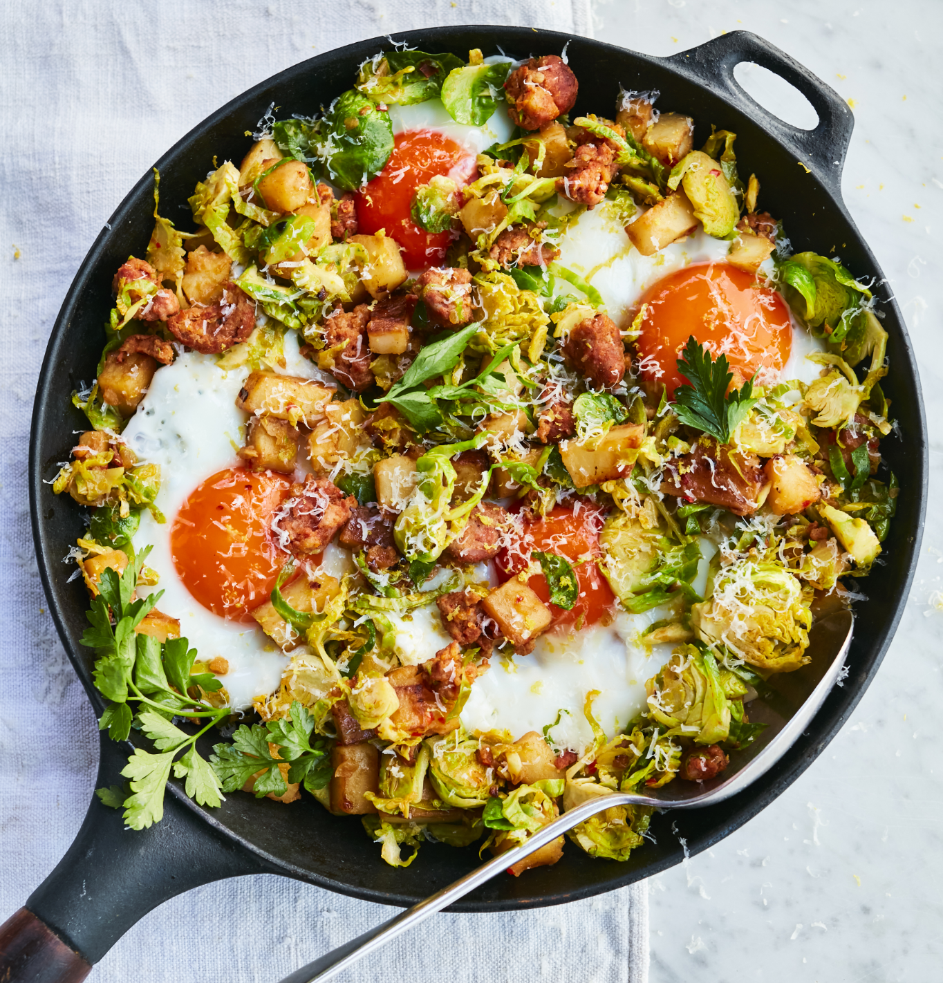 Aerial shot of potato and egg hash on a light blue pastel background