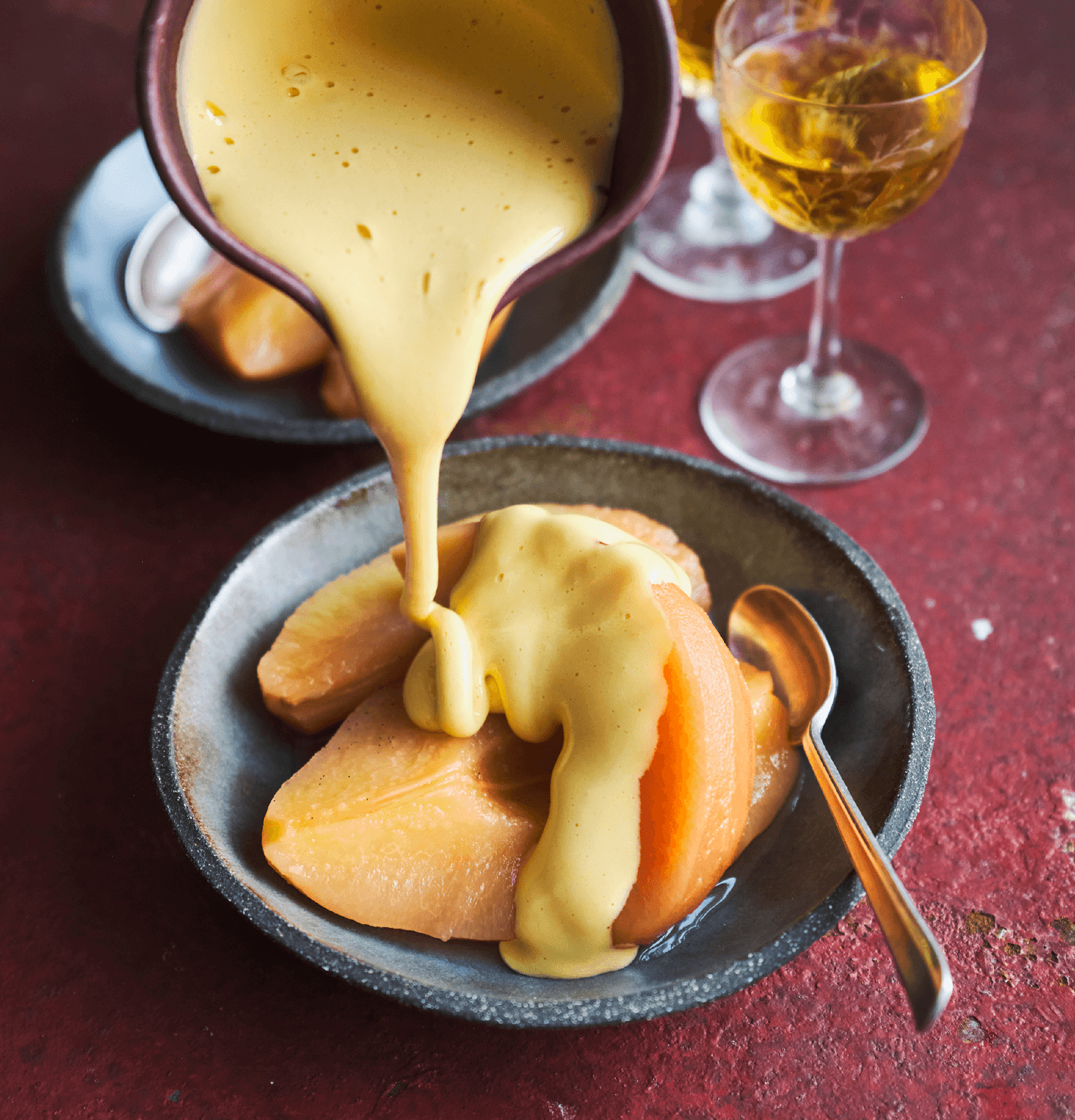 zabaglione being poured over some slices of poached quince