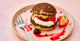 Choux buns with chocolate craqueline, chantilly cream and berries