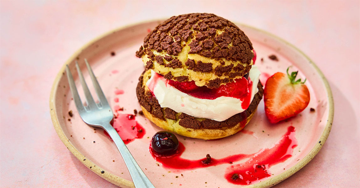 Choux buns with chocolate craqueline, chantilly cream and berries